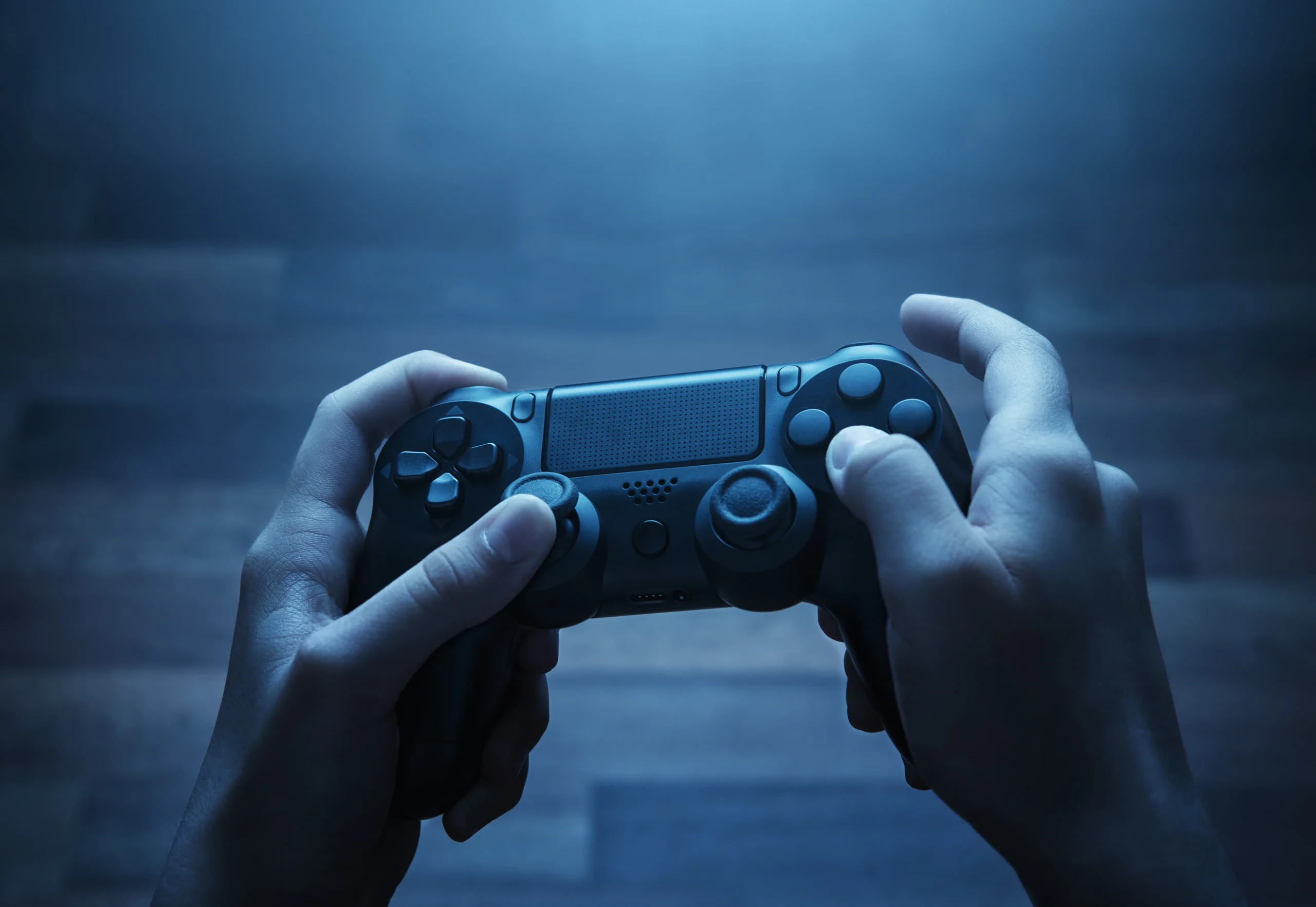 a person pressing the controller buttons of a video game system